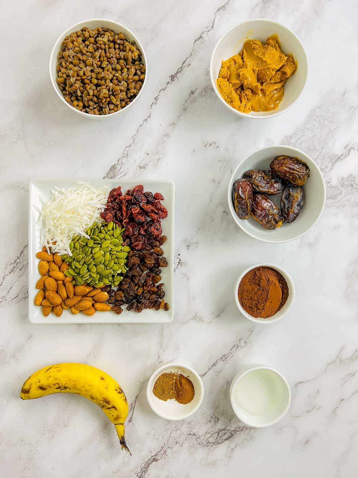 Ingredients to make lentil bars on a marble surface.