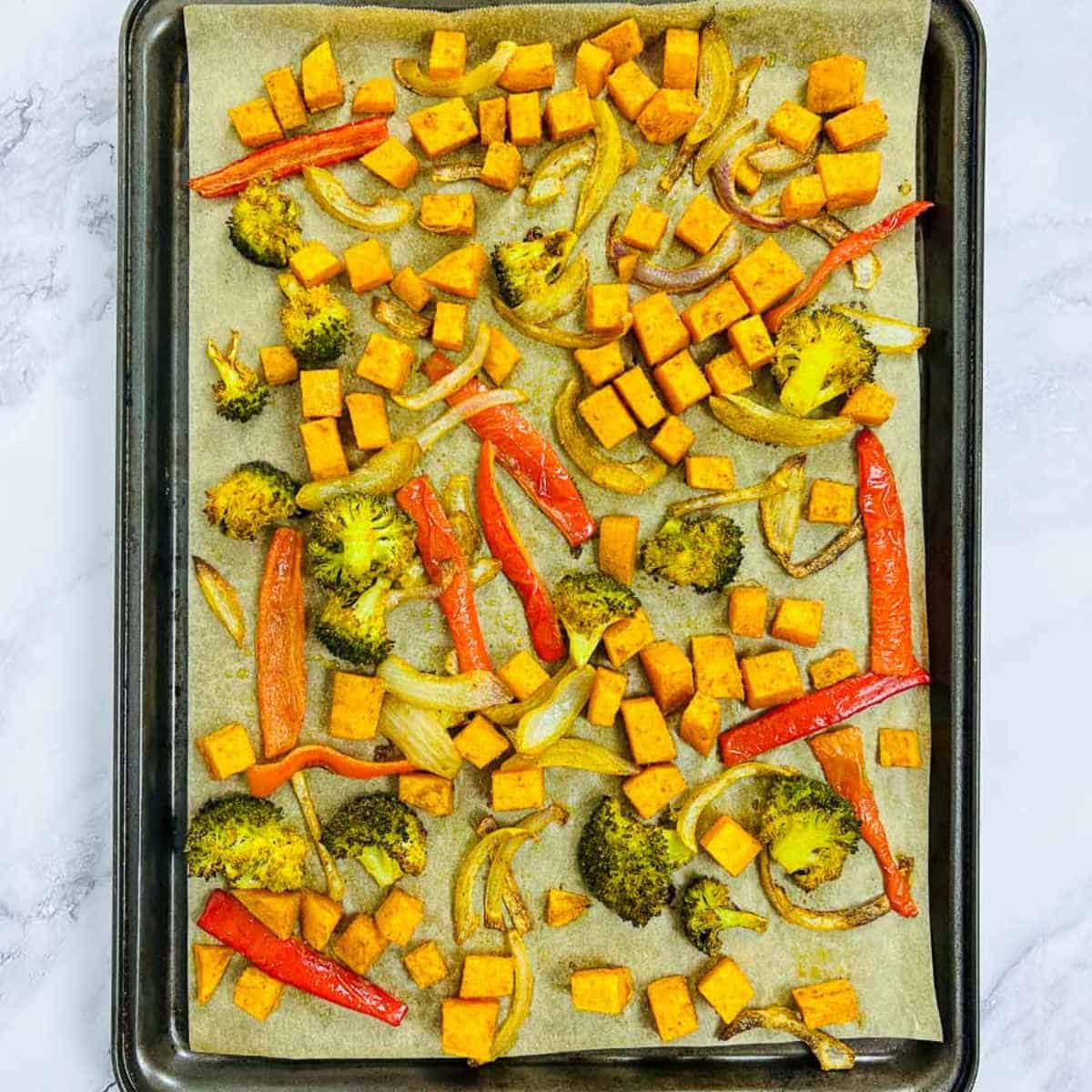 Roasted vegetables on a baking sheet.