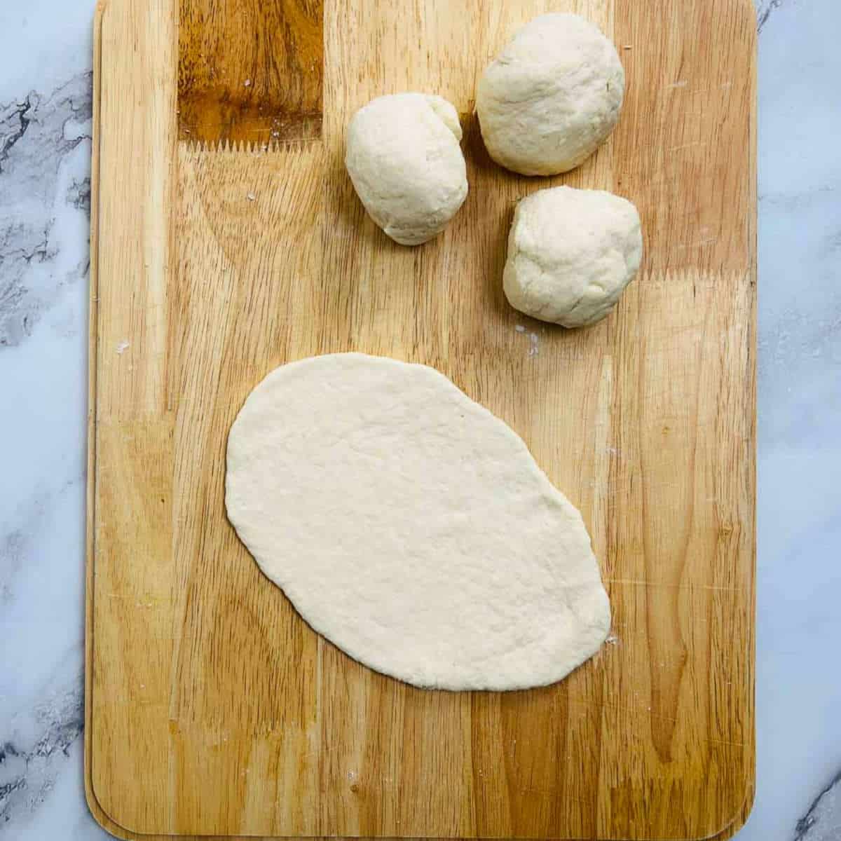 Rolled dough on a wooden board.