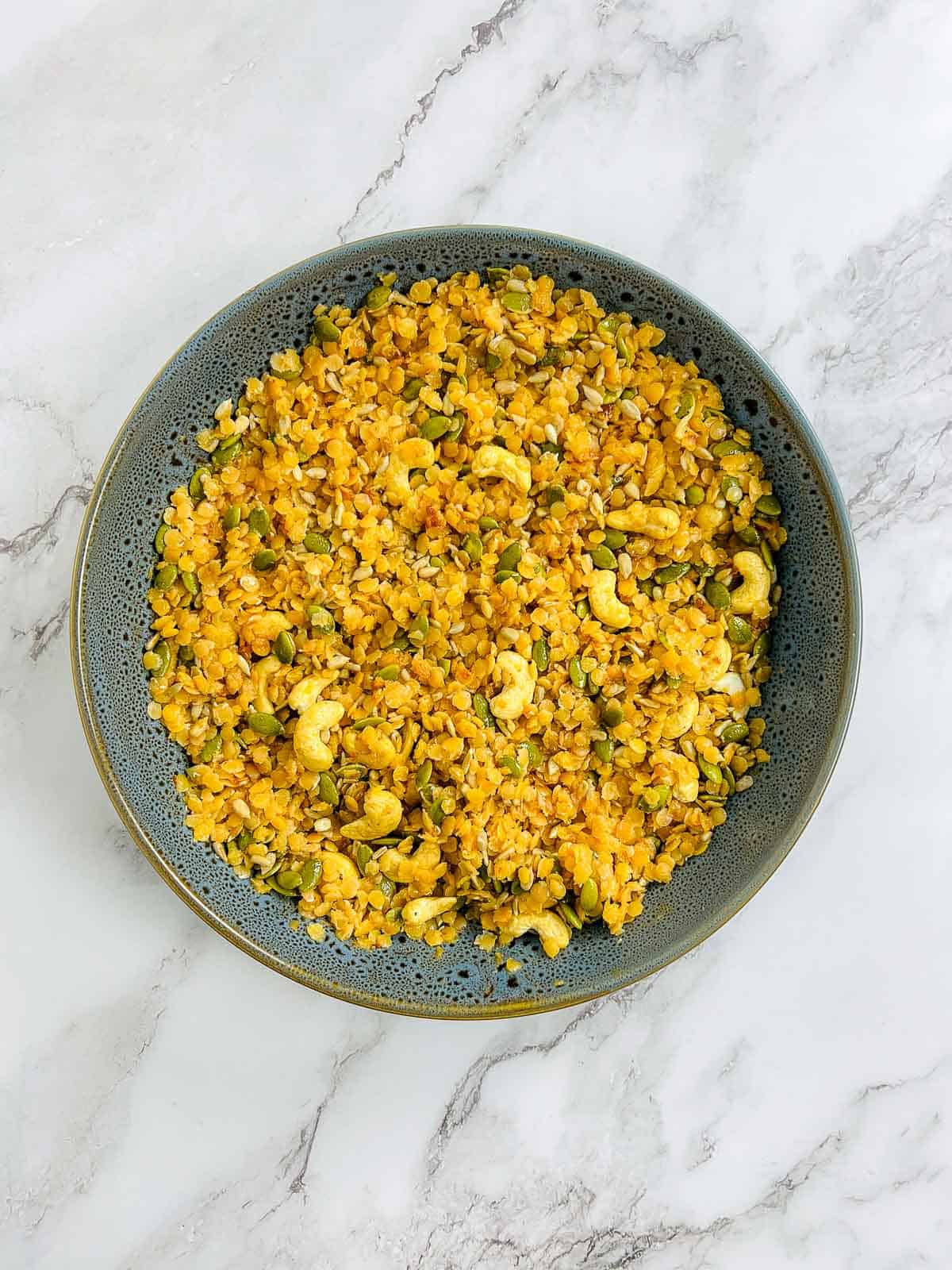 Boiled lentils mixed with other granola ingredients.