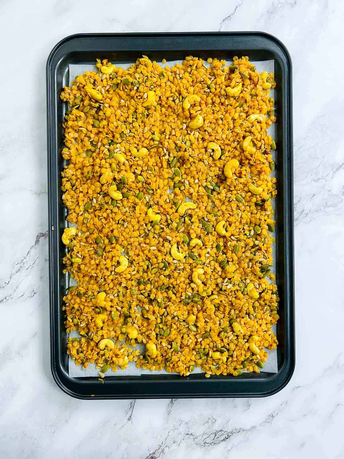 Lentil mixture on a lined baking sheet.