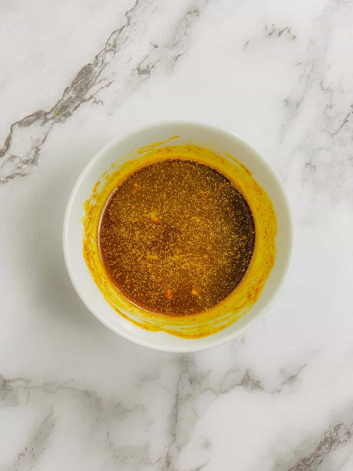Combine spices and oil in a small bowl.