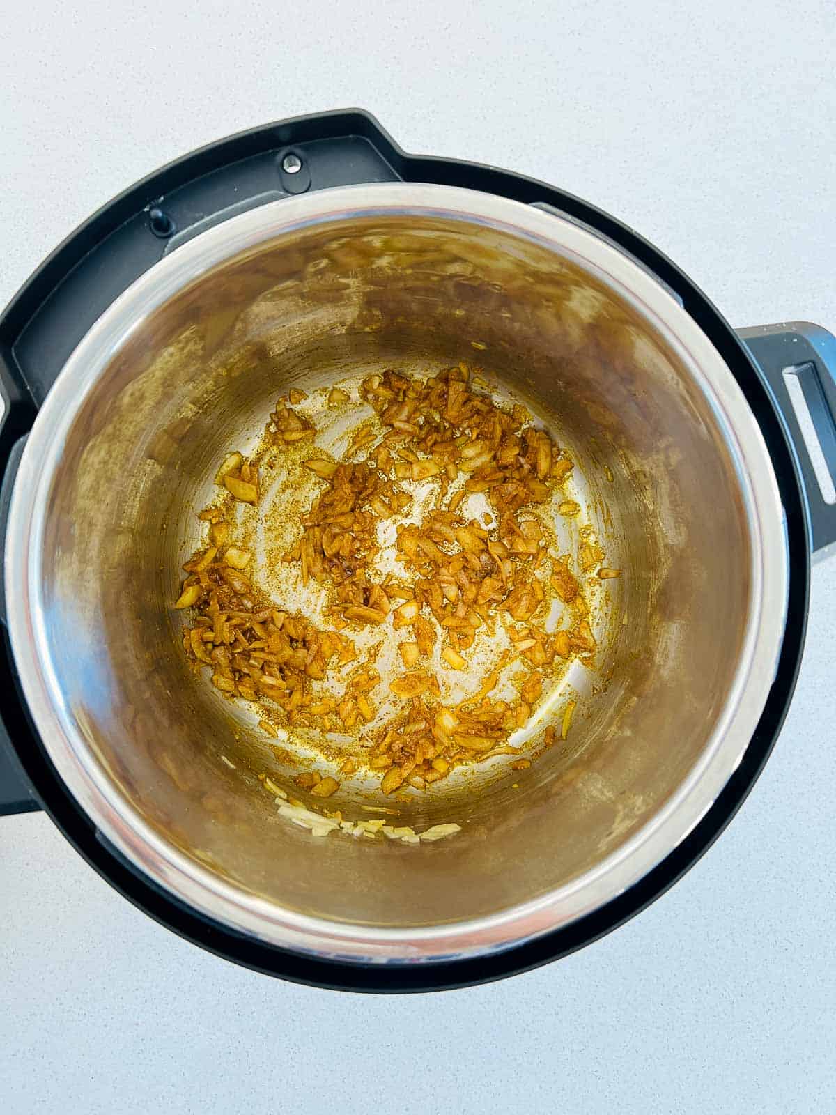 Sauted garlic, onion, and spices in the Instant Pot.