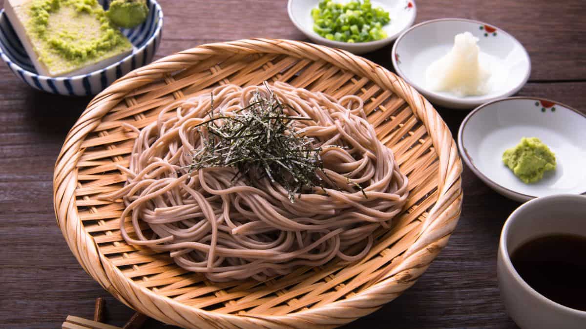 Soba noodles on a wooden plate.