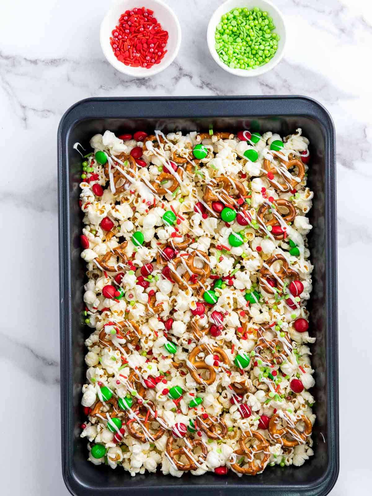 Mixing red and green sprinkles.