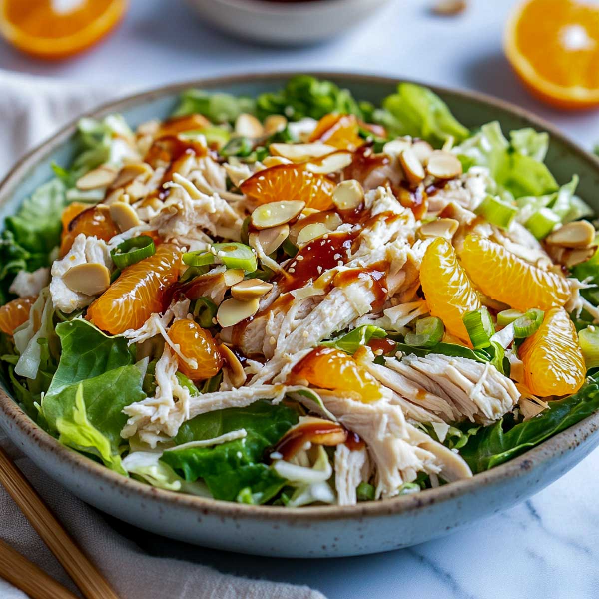 Side view of a large bowl of Asian chicken salad.