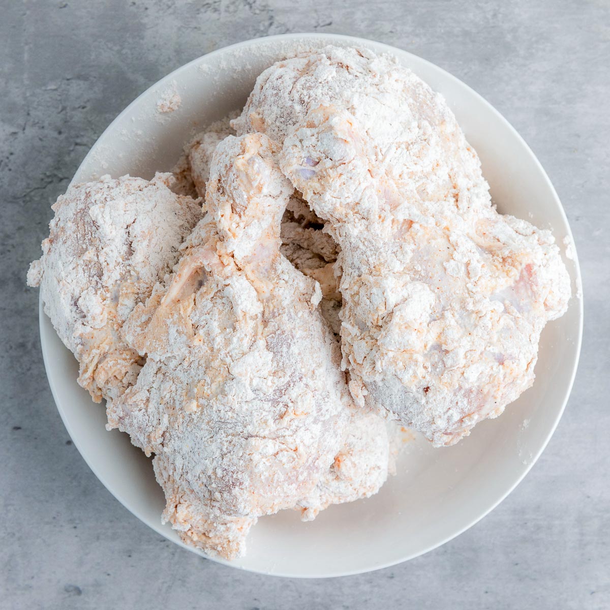 Marinated chicken dretched in flour.