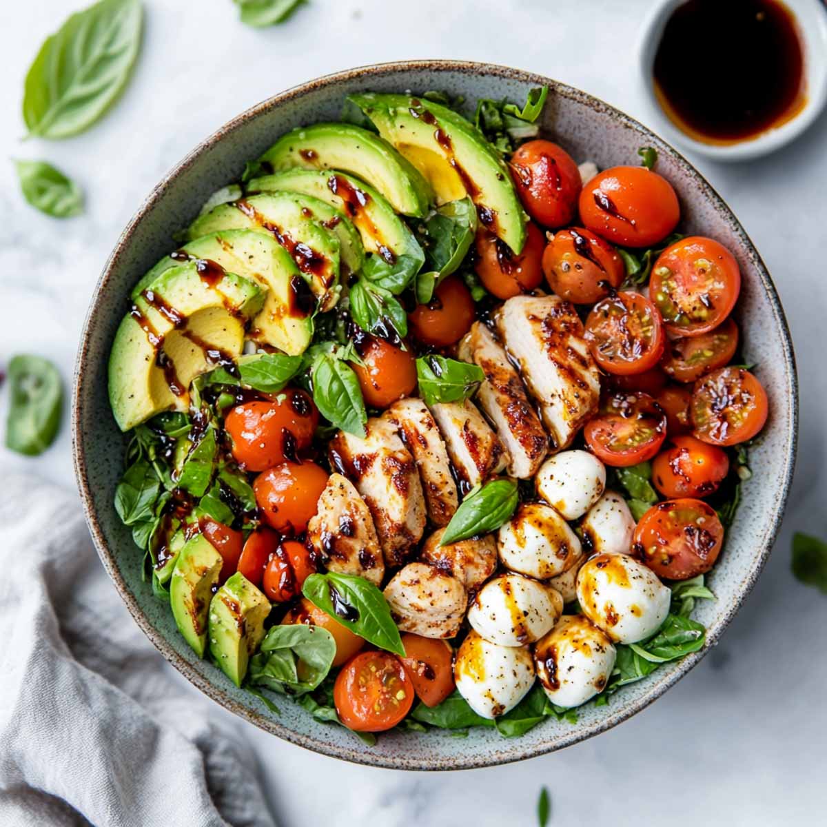Top view of chicken avocado caprese salad.