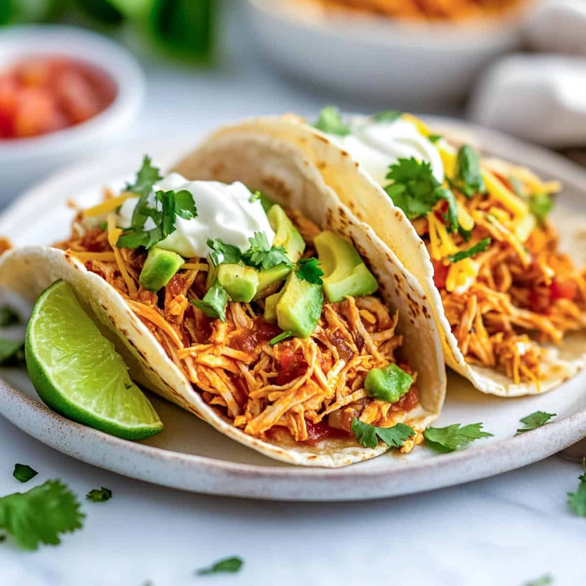 Assembled tacos placed on a white serving plate.