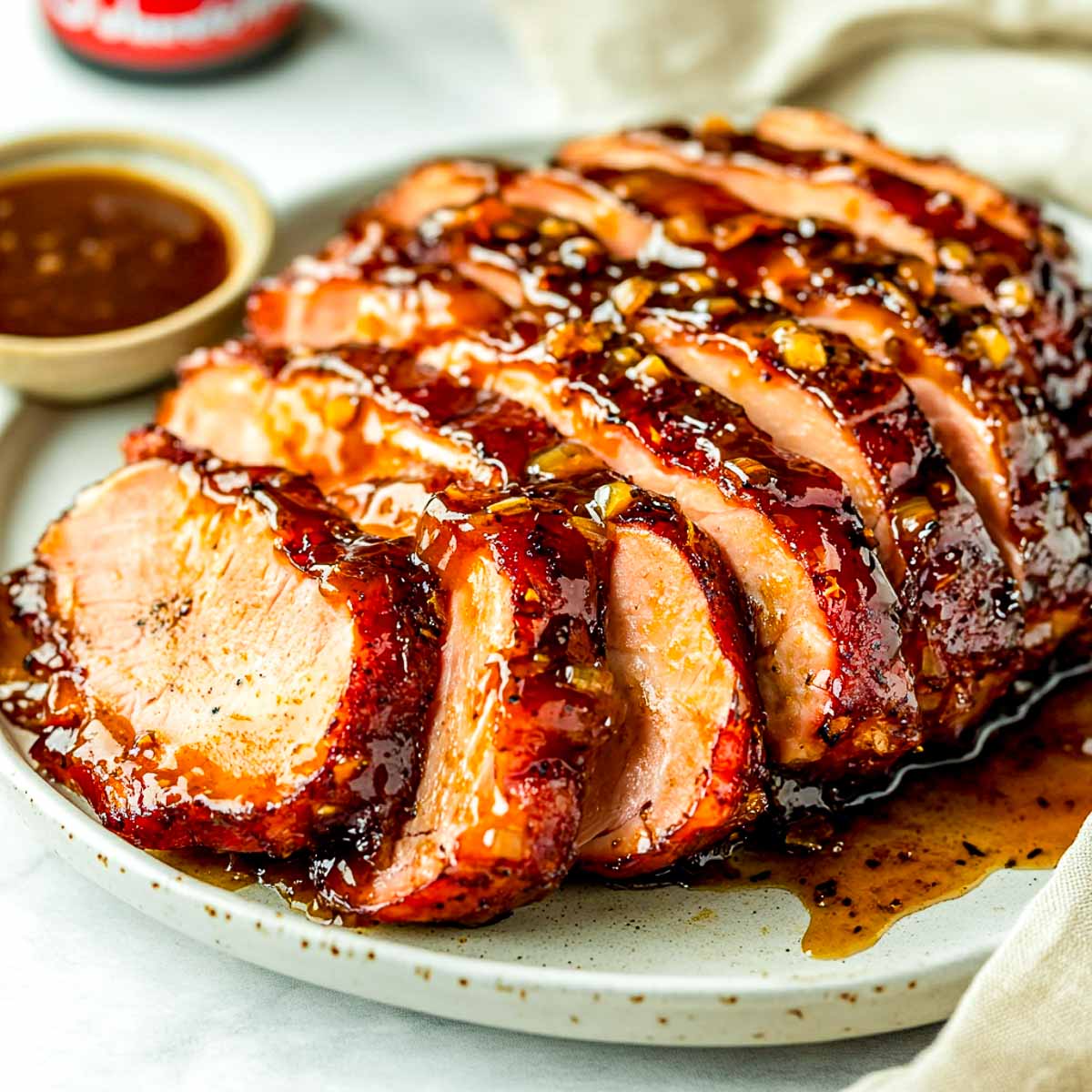Pepper ham sliced and served on a white plate.