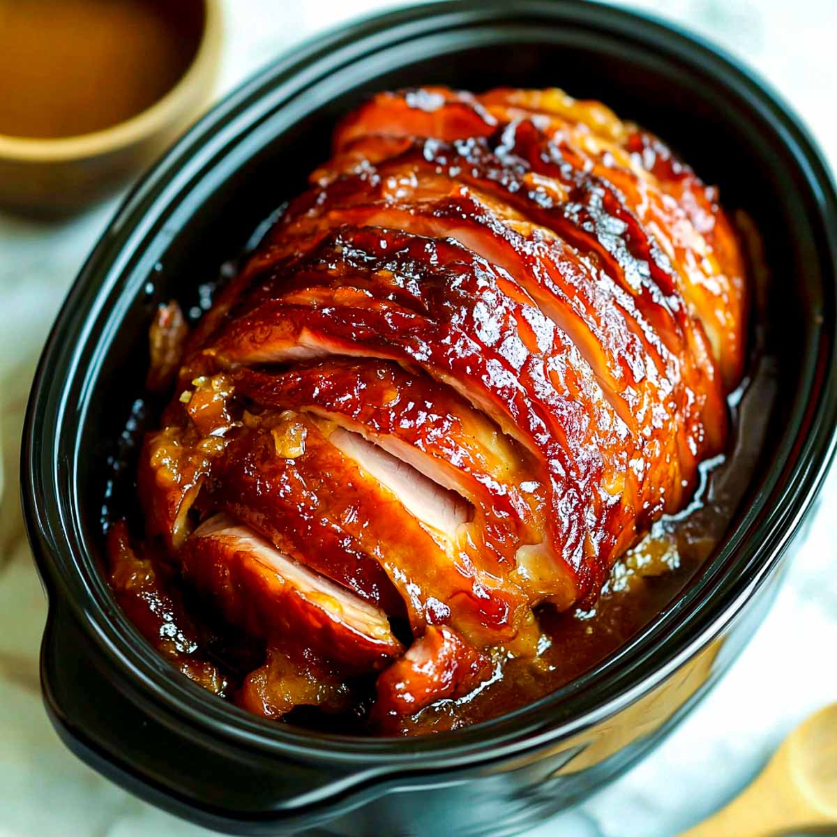 Honey baked ham inside a crockpot.