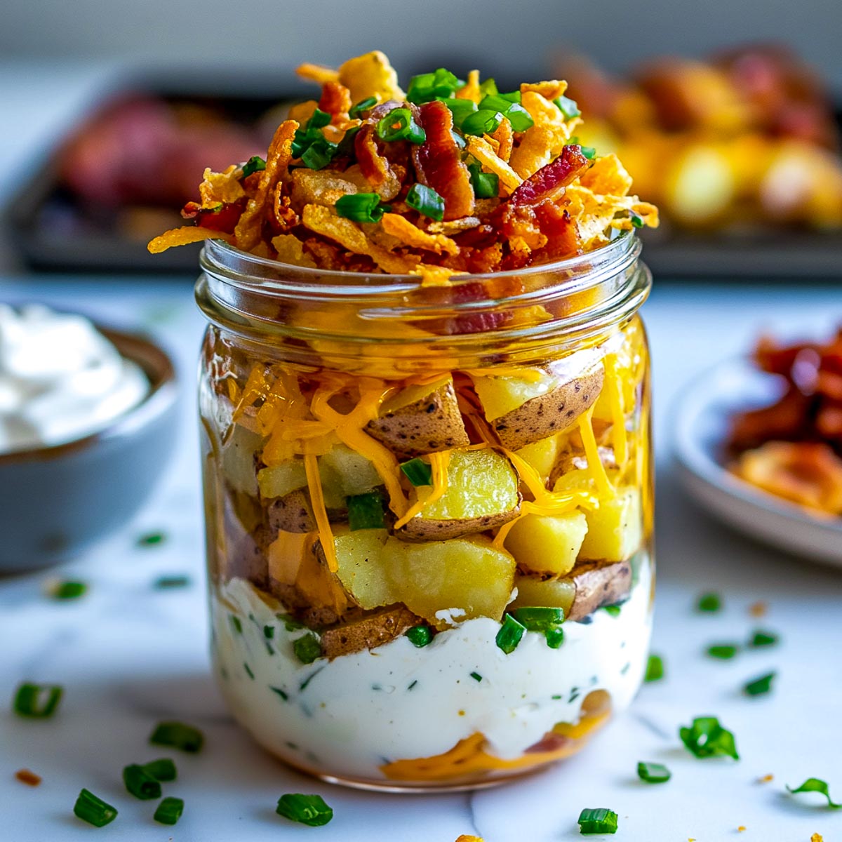 Side view of loaded baked potatoes meal.