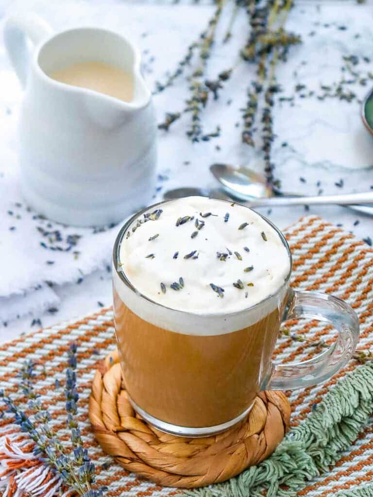 London fog latte with a milk jug in the background.