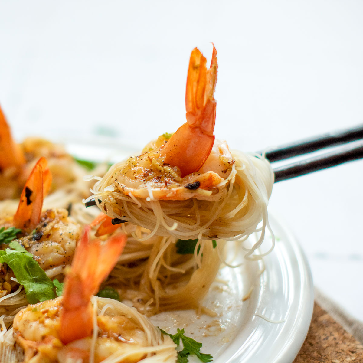 Shrimp and noodles picked using chopsticks.