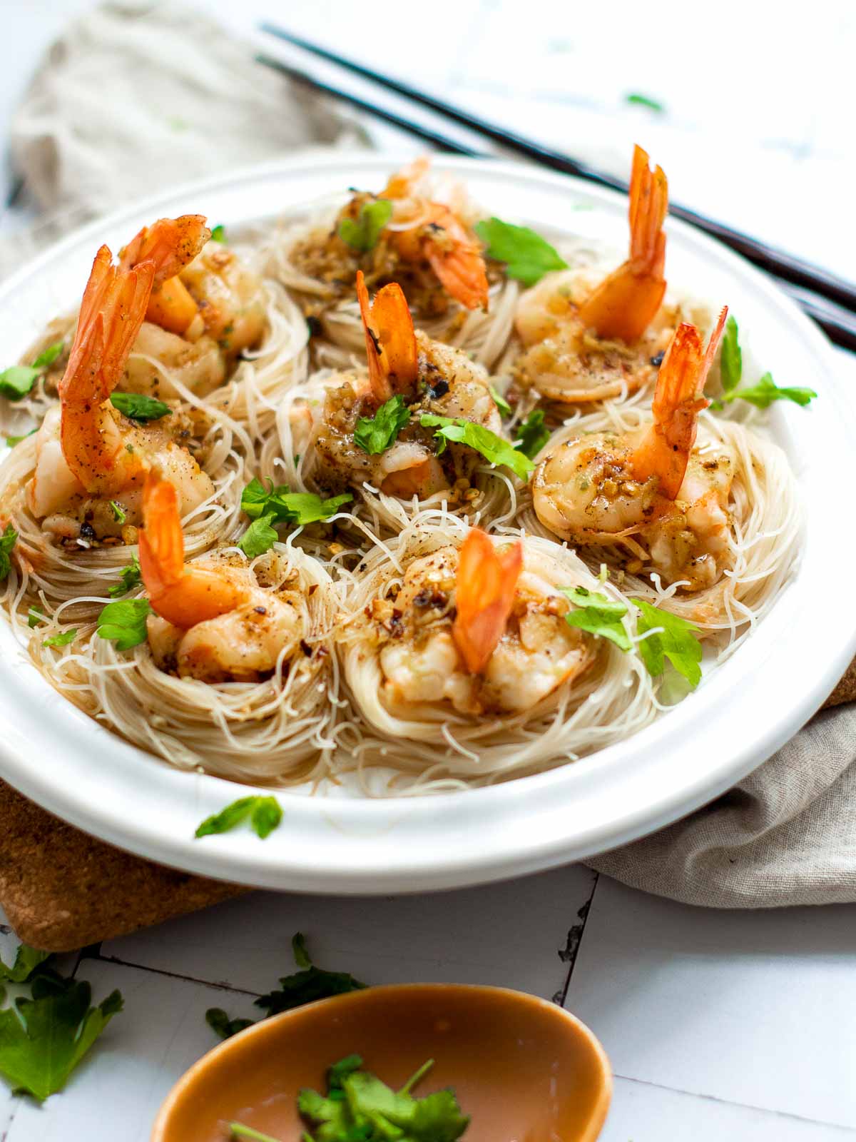 Shrimp boats placed on rice noodles and topped with garlic-chili butter.