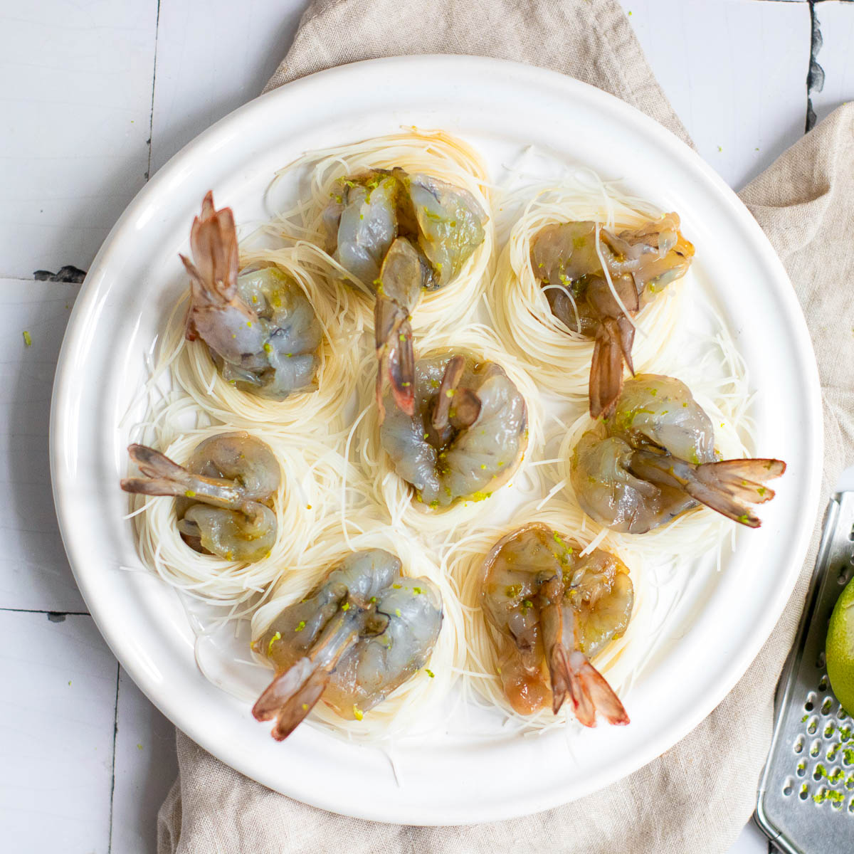 Shrimp boats placed on noodle nest.