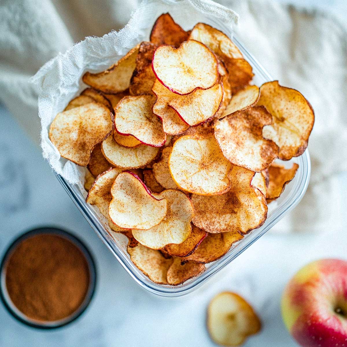 Apple cinnamon chips stored in a reusable container.