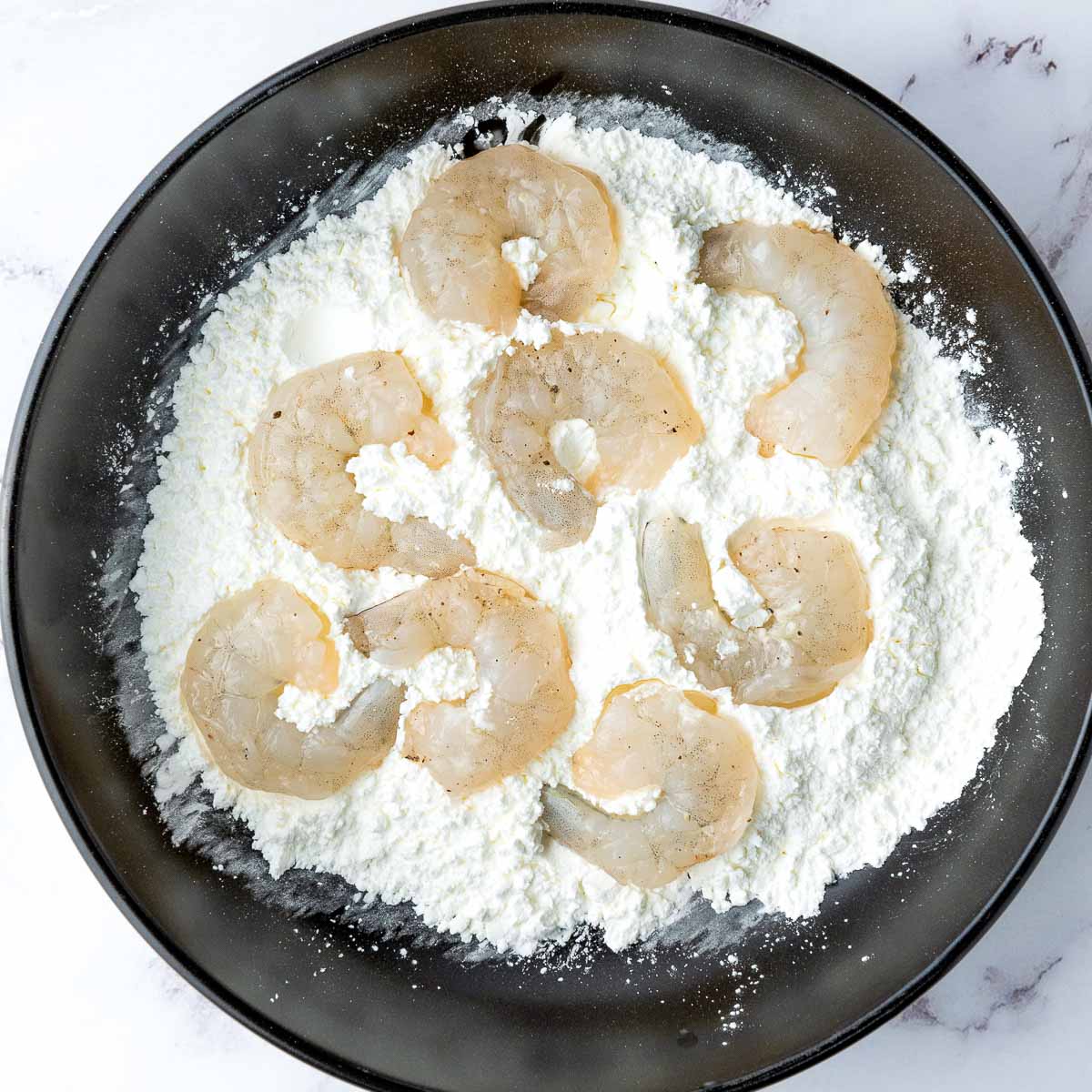Seasoned shrimp coated in cornstarch.