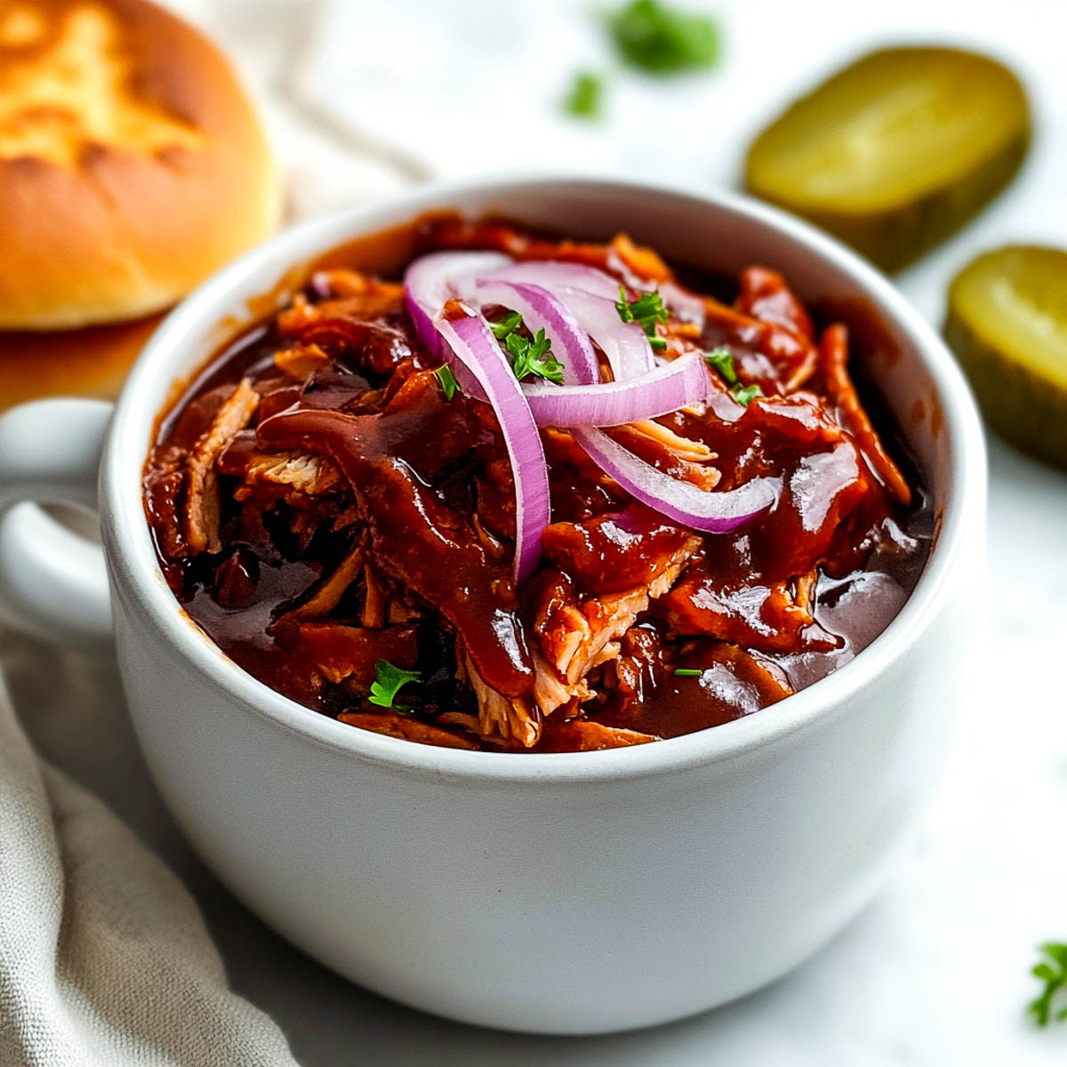 Shredded bbq jackfruit topped with red onions.