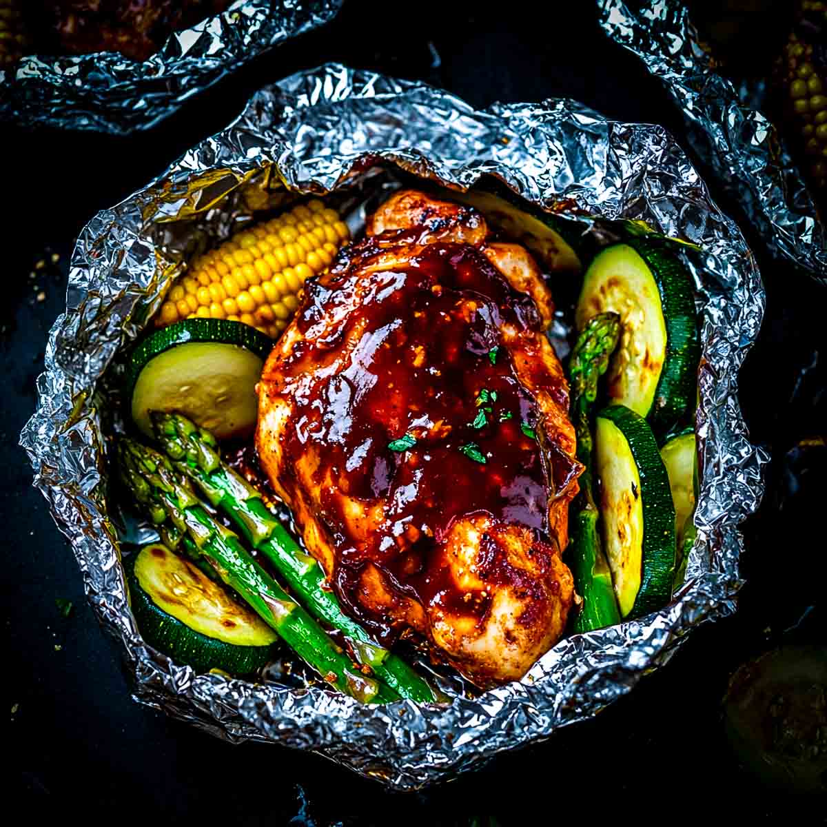 Chicken and veggies cooked in foil packets.