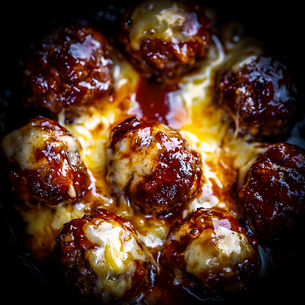 Close up of cheesy meatballs.