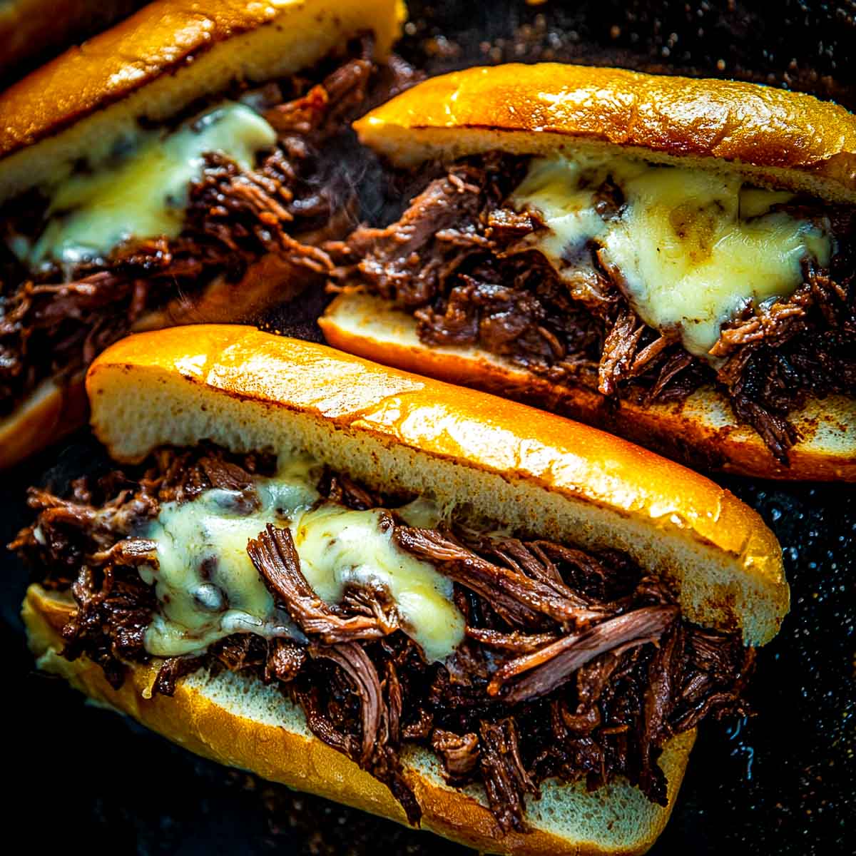 Close up of assembled french dip sandwiches.