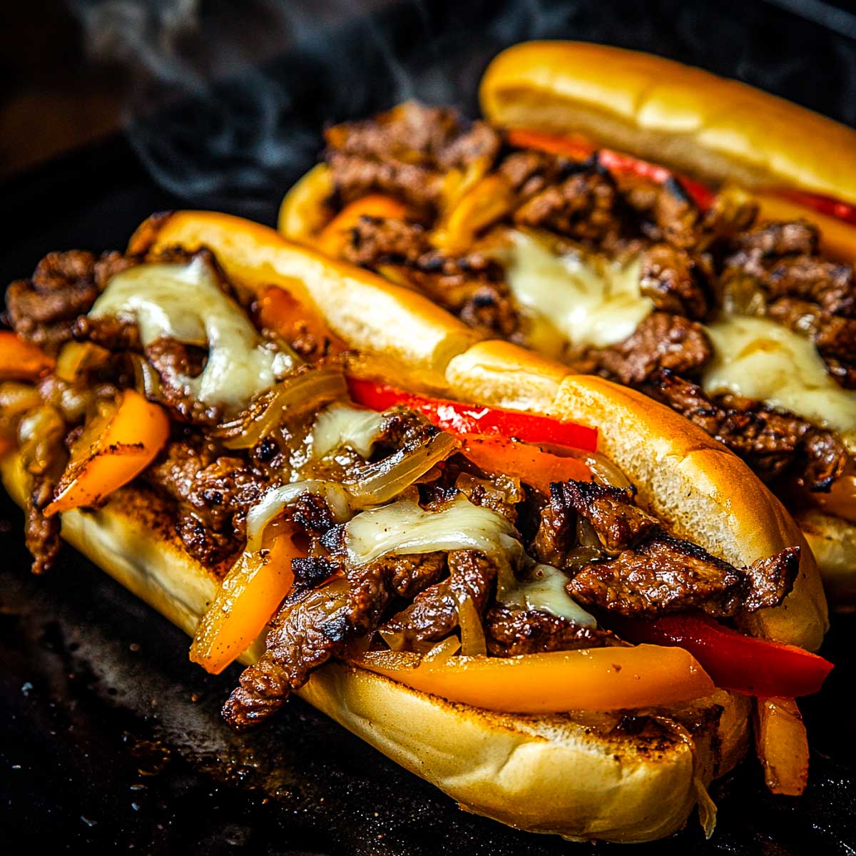 Close up of cheesesteak hoagies.
