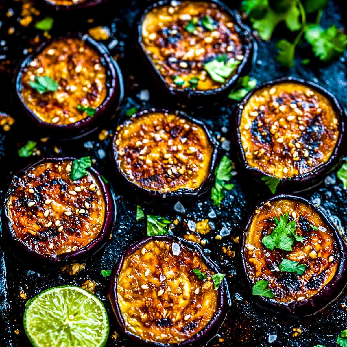 Campfire eggplant rounds garnished with cilantro.