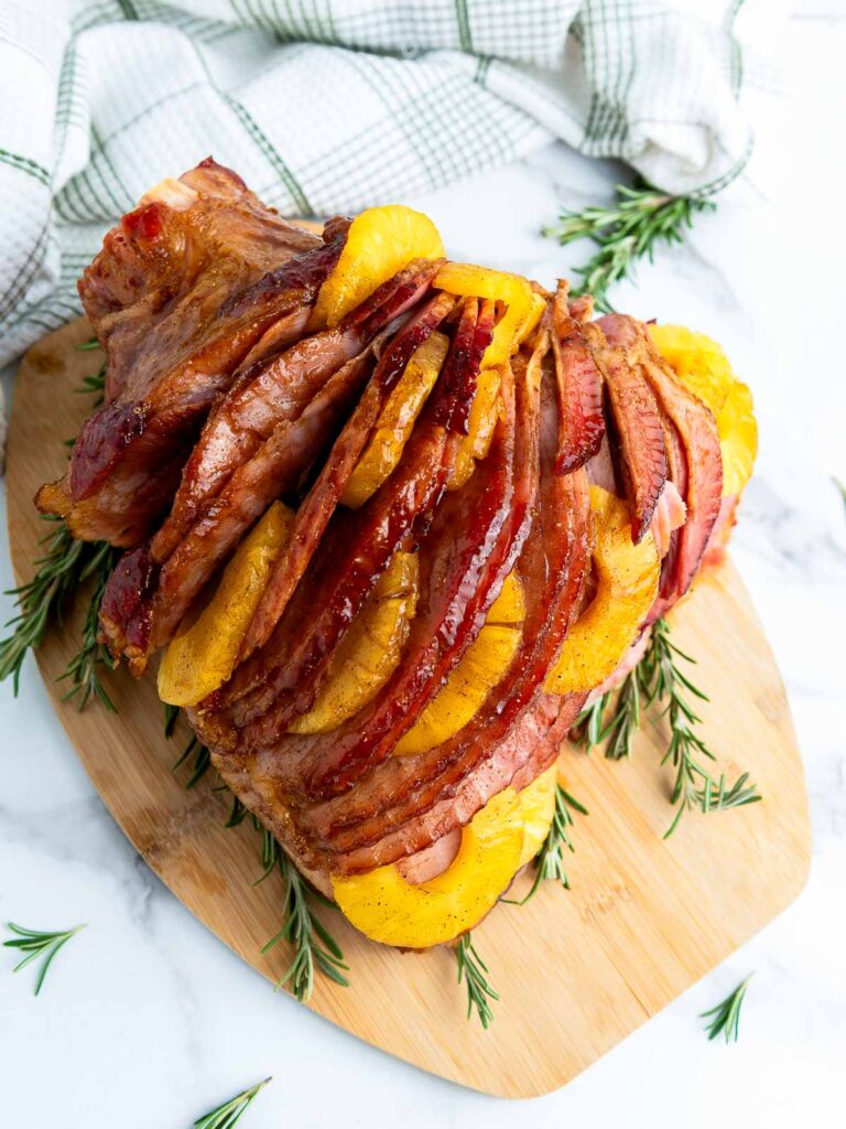 Top view of brown sugar and pineapple ham placed on a wooden board.