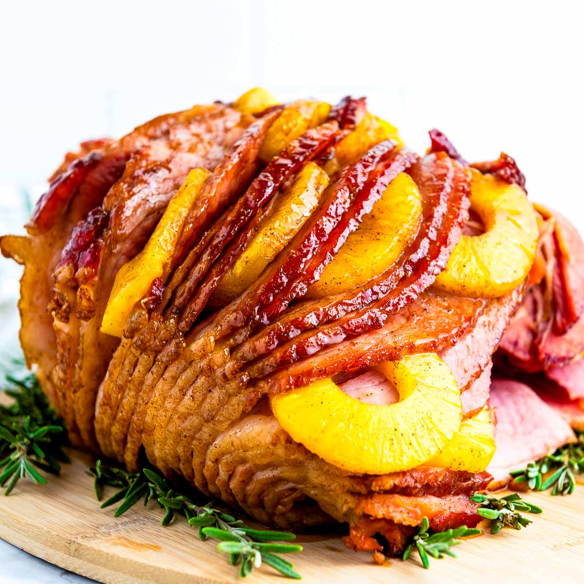 Close up view of pineapple ham placed on a wooden board.