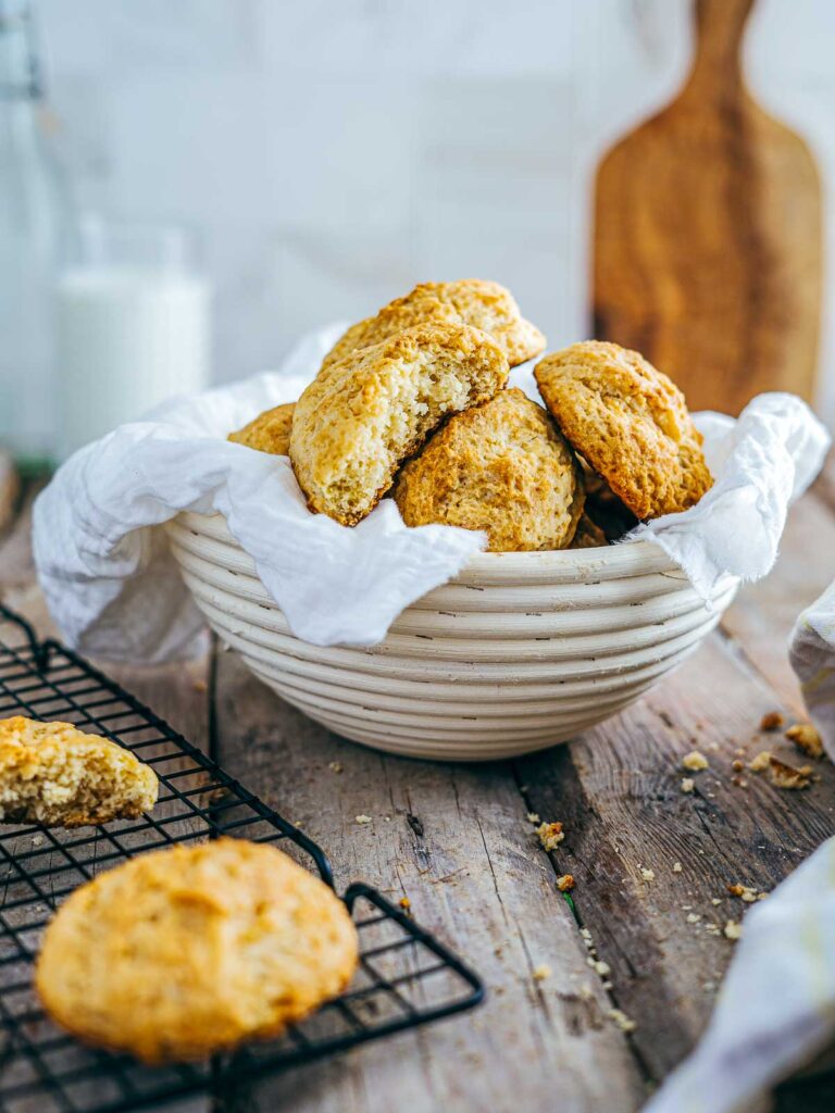 Side view of buttermilk drop biscuits on a wooden surface.