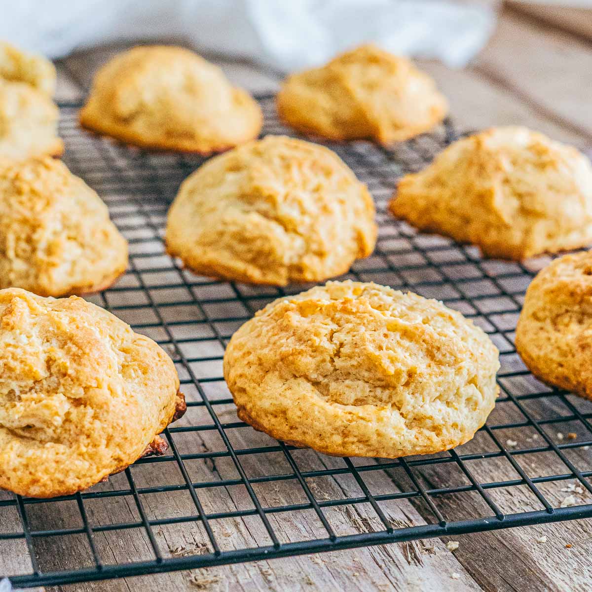 Side view close up of buttermilk drop biscutis on a wire rack.