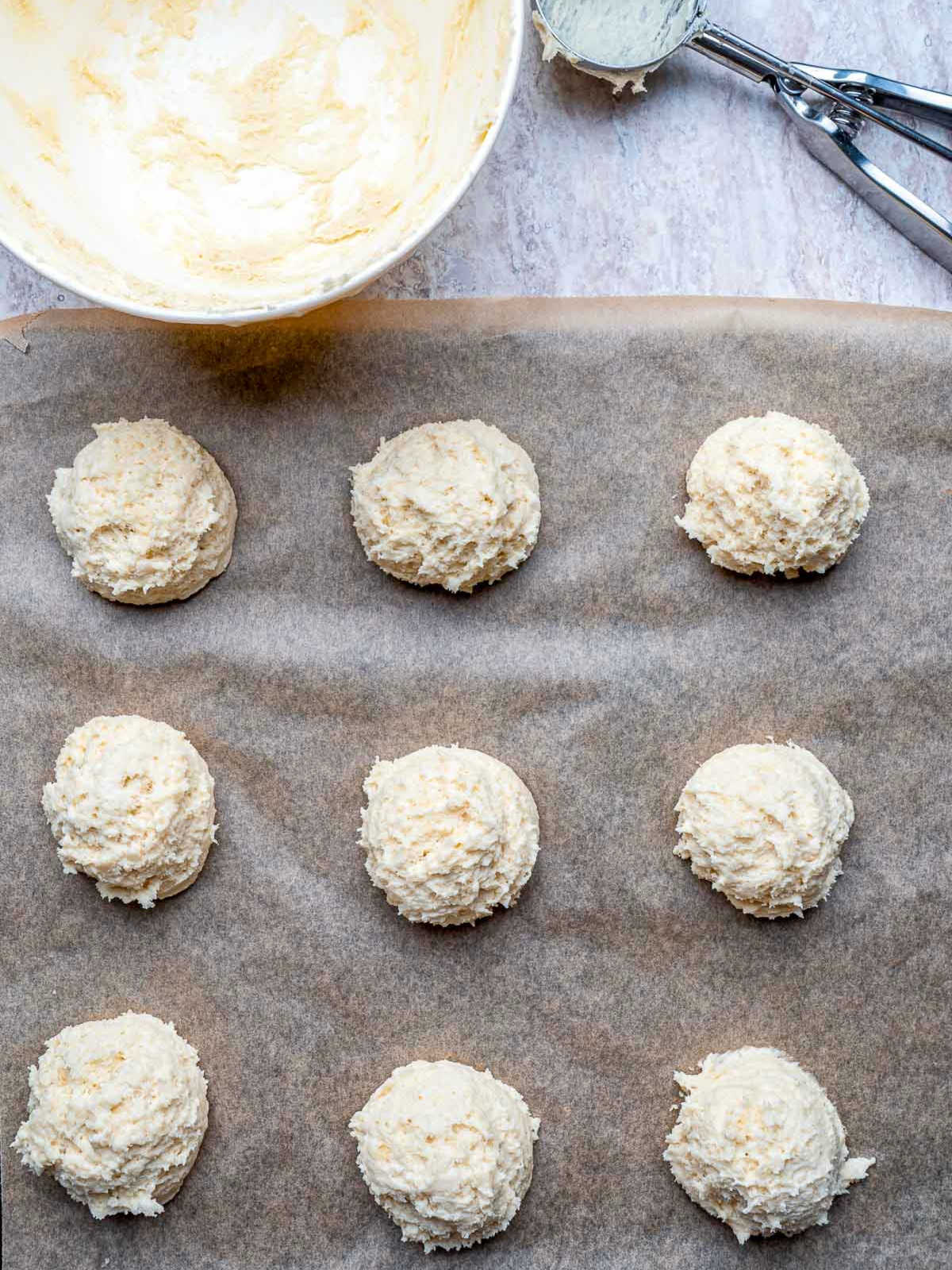 Dough scooped and placed on a lined baking tray.