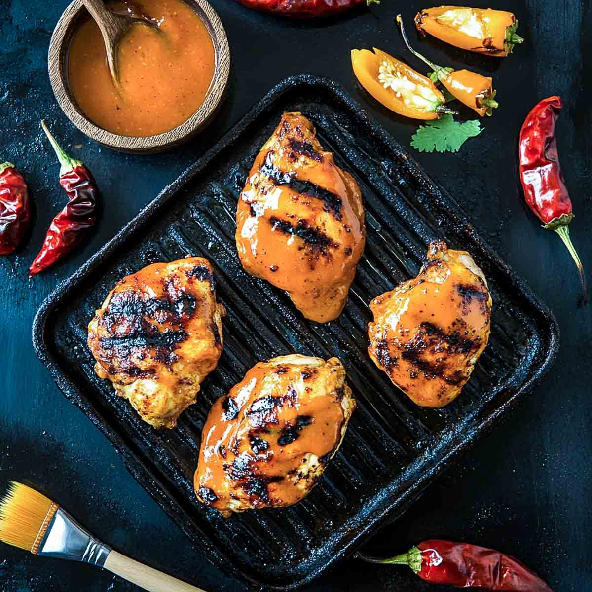 Mango habanero marinated chicken breast on a grill pan.