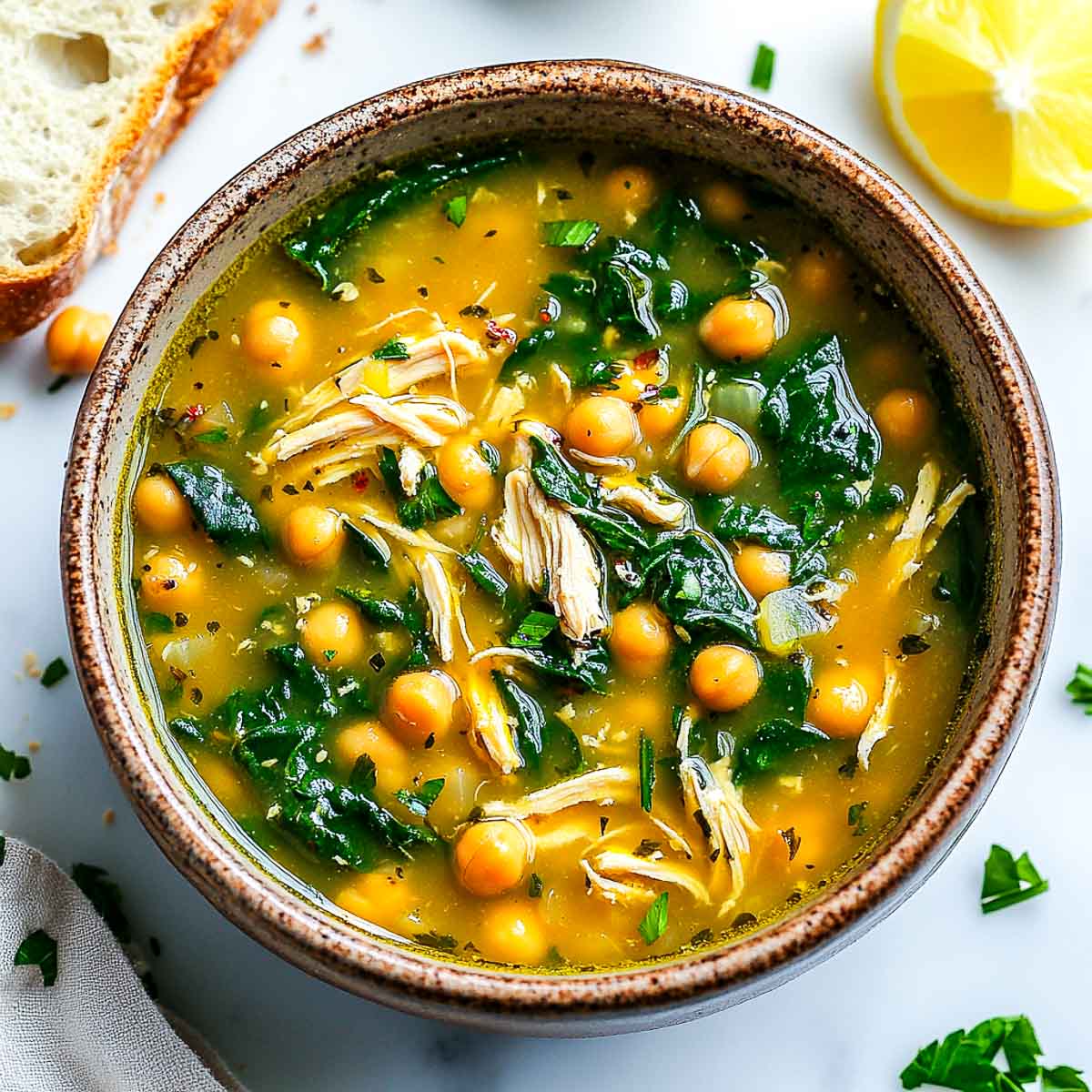 A bowl of soup served with crusty bread.