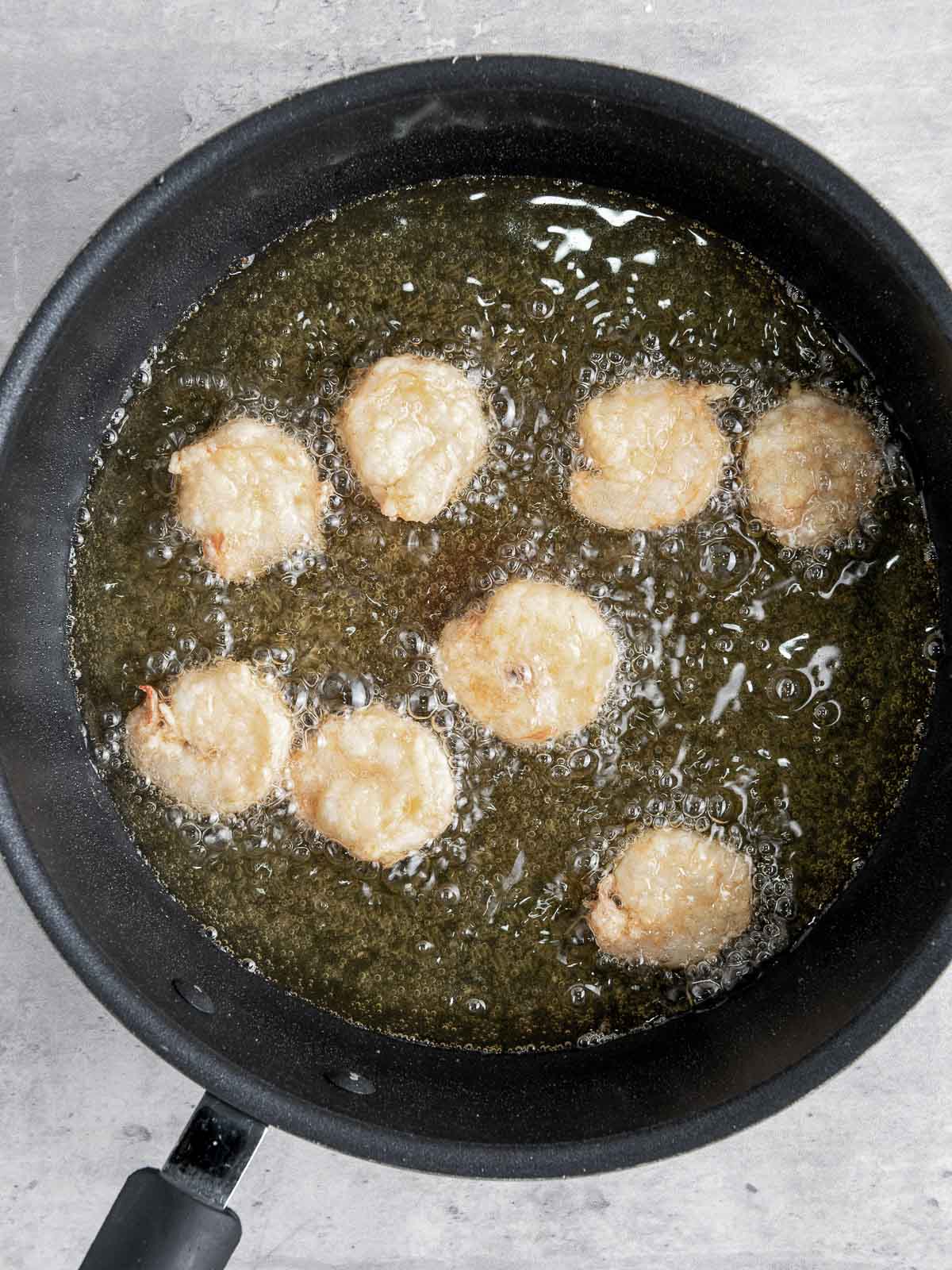 Shrimp fried in a skillet.