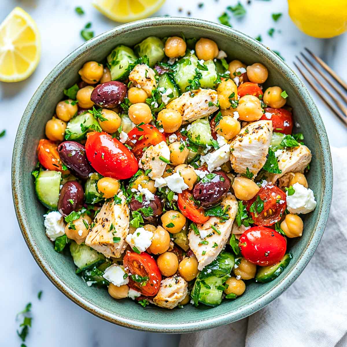Chopped chicken chickpea salad in a green serving bowl.