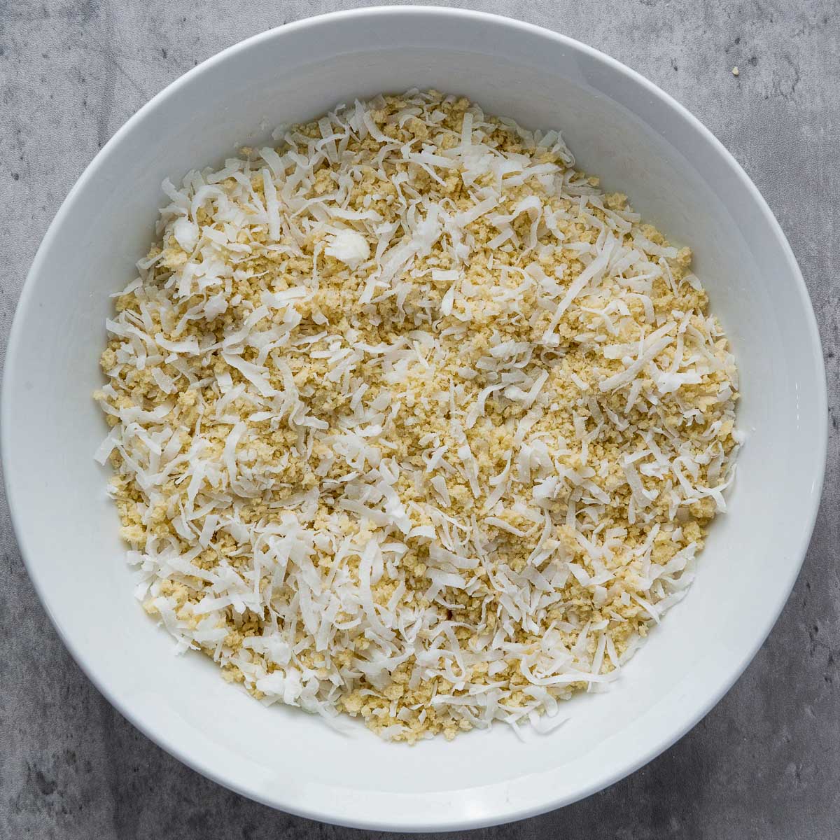Coconut and breadcrumb coating in a wide bowl.