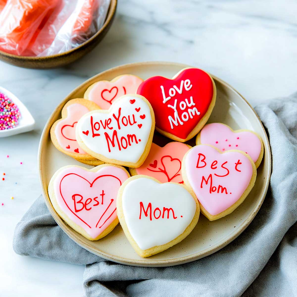 Heart-shaped sugar cookies with pink and white icing.
