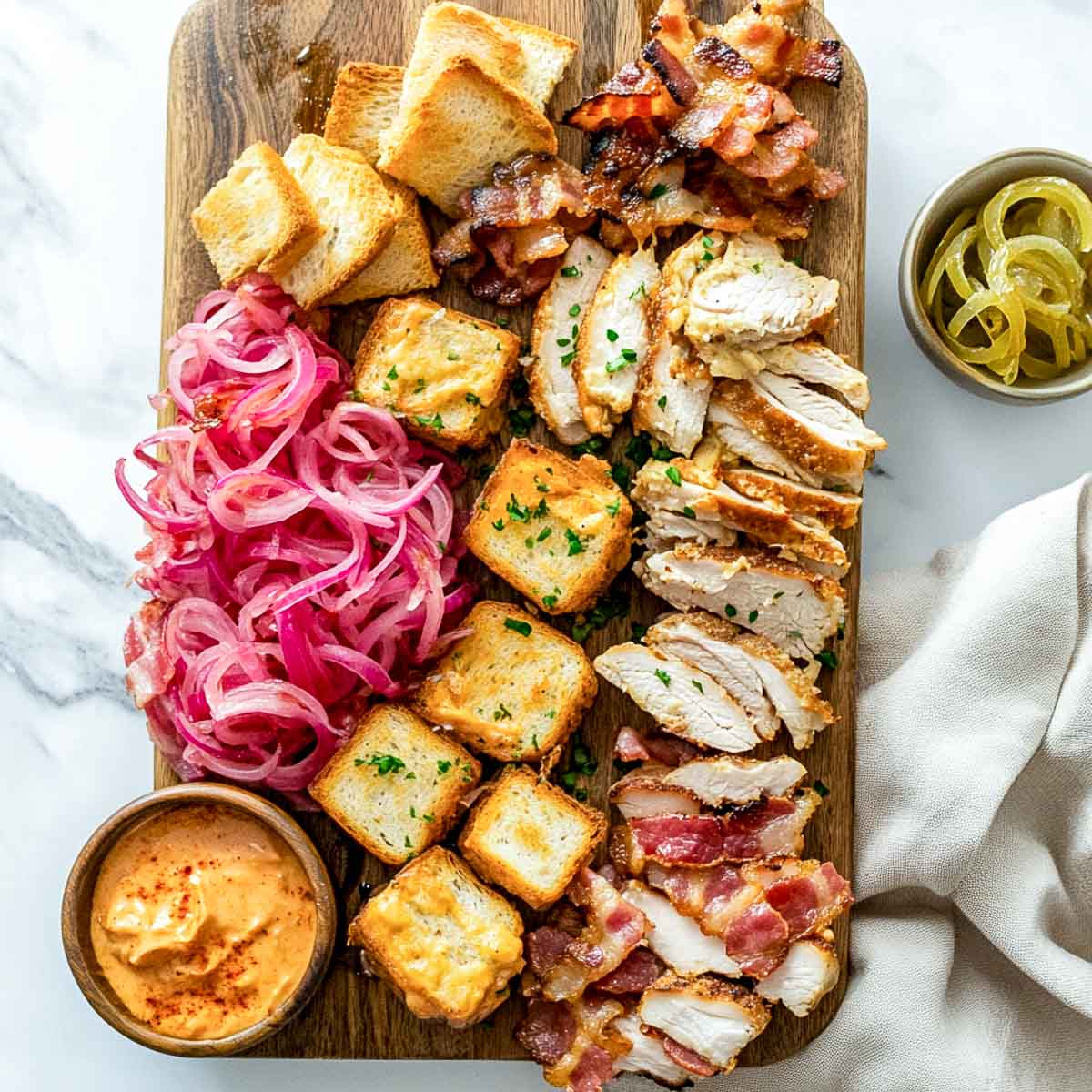 Hot brown grazing board elements placed on a marble surface.