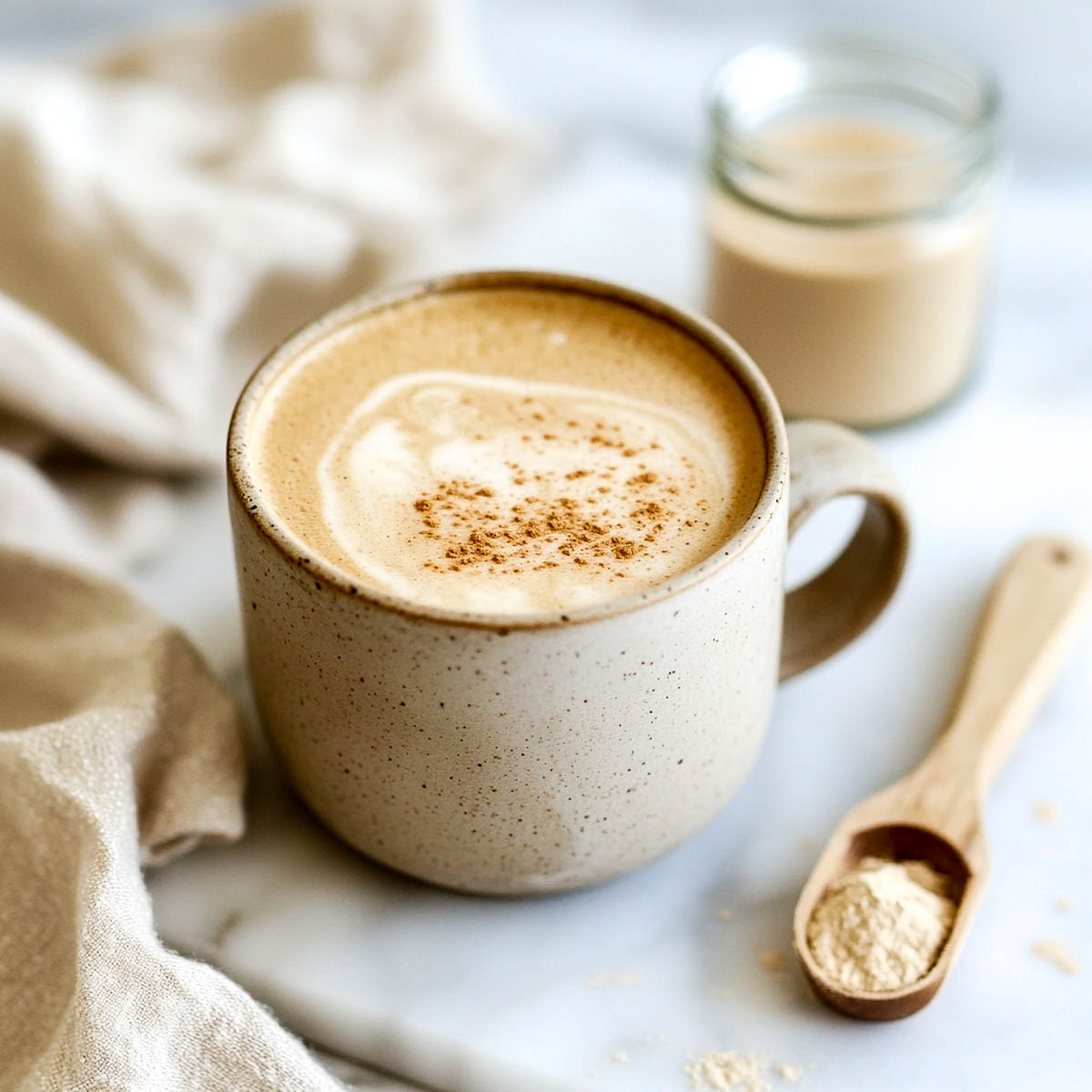 High protein collagen coffee mug on a white marble surface.