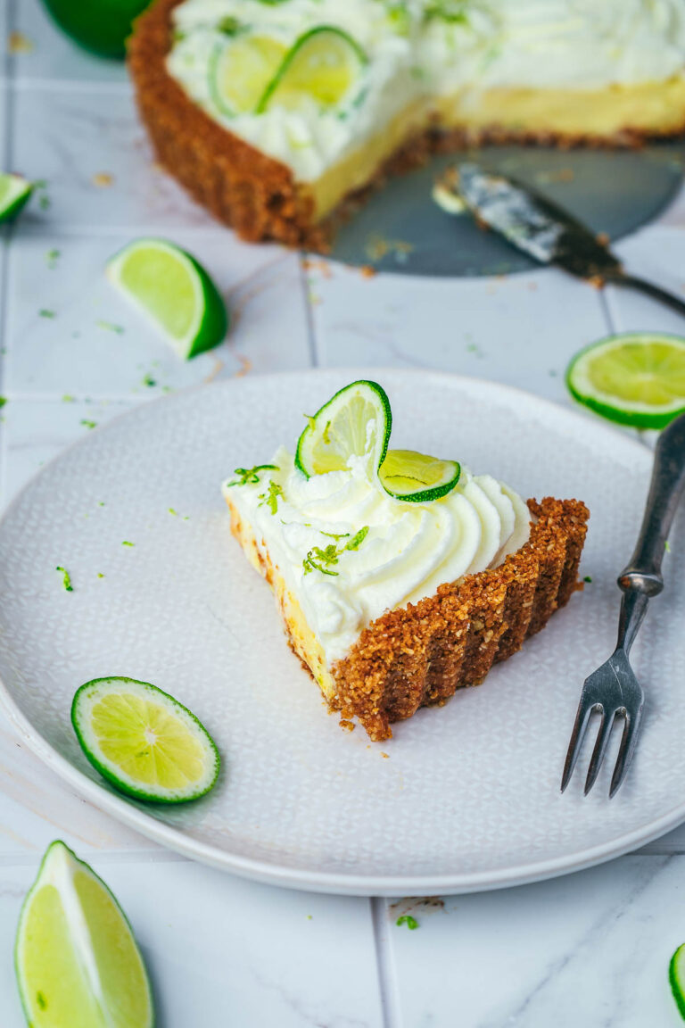 A slice of key lime pie on a white serving plate.