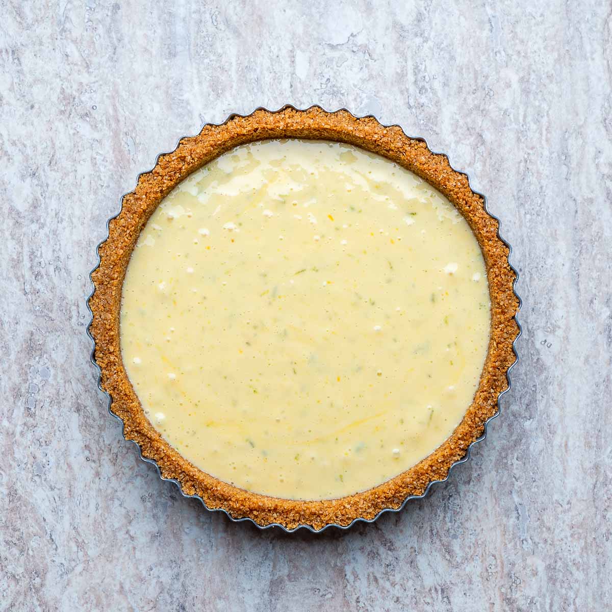 Pie crust topped with filling ready to be baked.