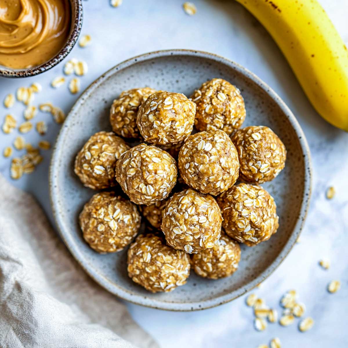 Peanut butter and banana energy balls on a marble surface.