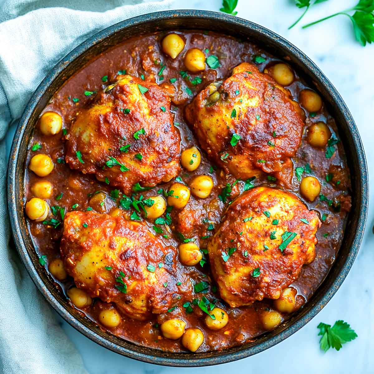 Paprika chicken and chickpeas cooked in a skillet.