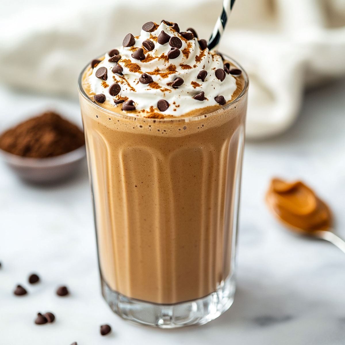 Peanut butter mocha shake topped with whipped cream and chocolate chips.