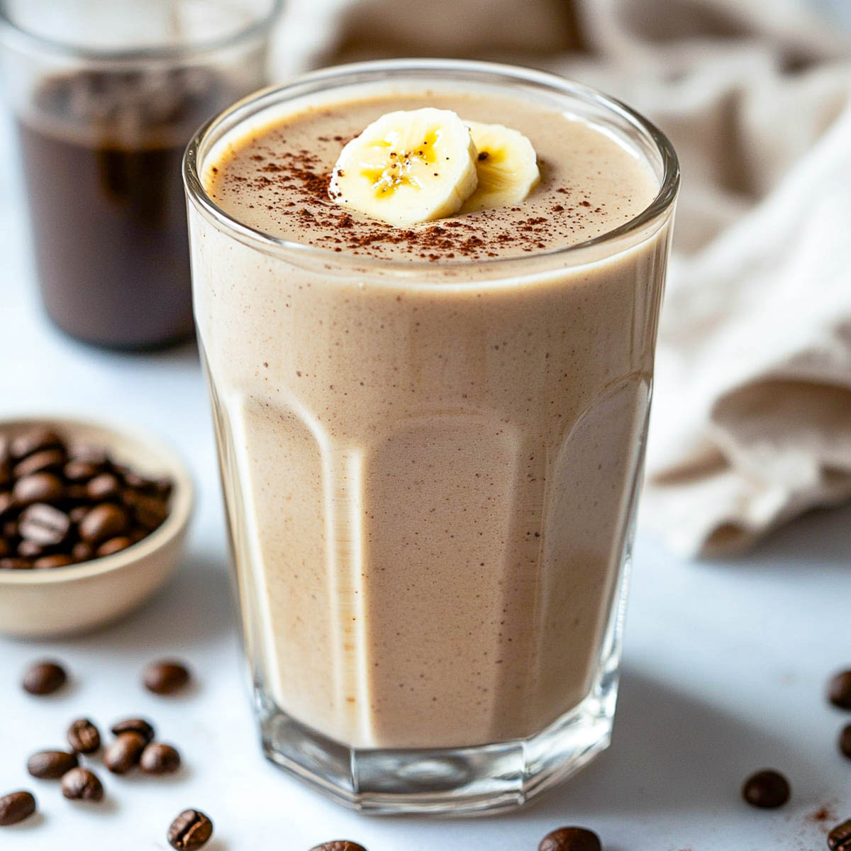 Protein coffee smoothie topped with banana slices.