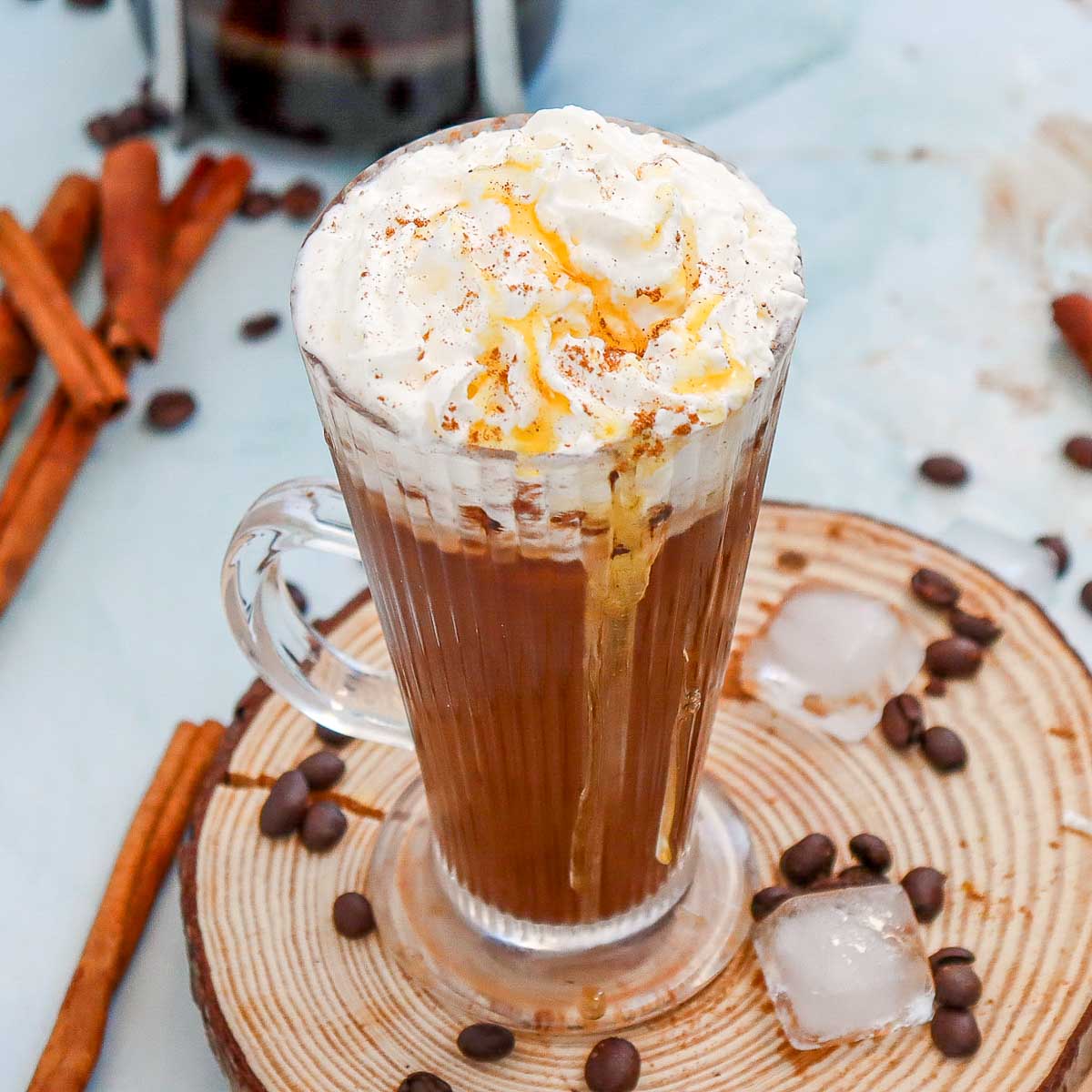Slightly angled shot of cinnamon dolce latte placed on a wooden board.
