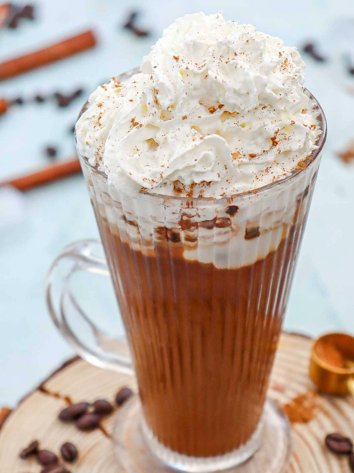 Coffee topped with whipped cream and cinnamon.