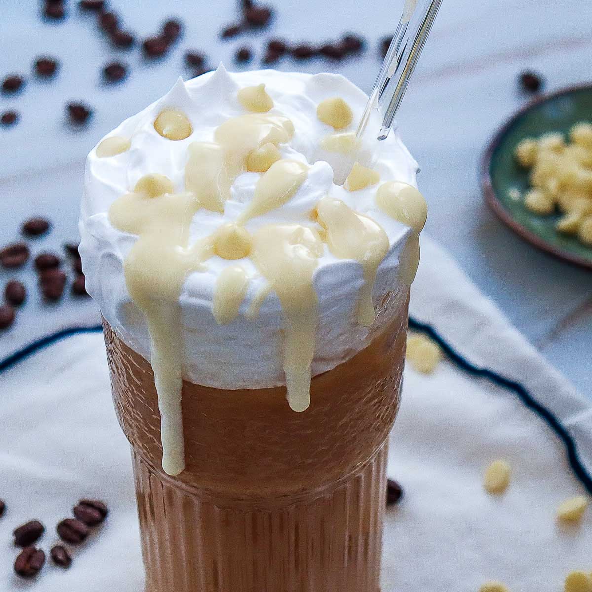 Close up of iced white chocolate mocha placed on a marble surface.